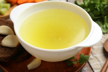 Tasty chicken bouillon served on table, closeup