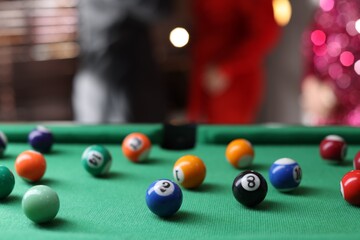Many colorful billiard balls on green table indoors, closeup. Space for text