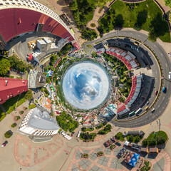 blue sphere inside overlooking old town, urban development, historic buildings and crossroads with cars. Transformation of spherical 360 panorama in abstract aerial view.