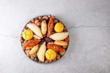 Traditional Azerbaijan holiday Novruz background with green semeni,traditional azerbaijan sweets,shekerbura,qogal,paxlava,mutaki and different nuts and sweets,top view,space for copy