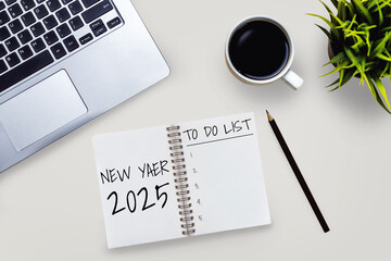 2025 Happy New Year Resolution Goal List and Plans Setting - Business office desk with notebook written about plan listing of new year goals and resolutions setting. Change and elation concept.