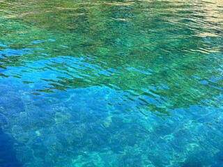 Glittering green blue clear water calm surface