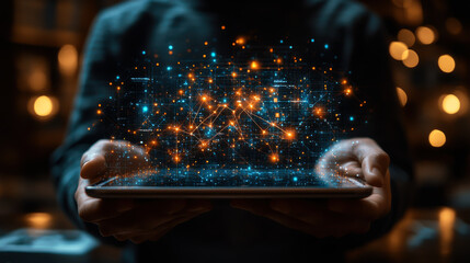 Person holding a tablet with glowing digital connections displayed in a dark environment
