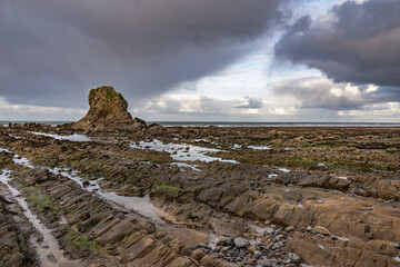 Widemouth bay rocks and winter skies at low tide