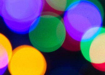 A closeup of colorful lights against a black background