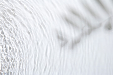 Rippled surface of clear water on white background, top view