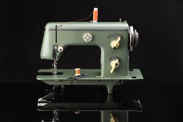 Vintage professional sewing machine on black background