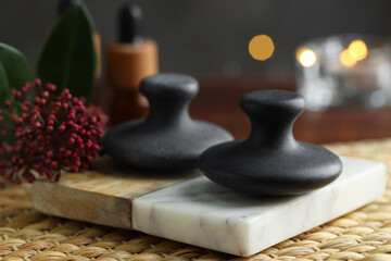 Spa stones and floral decor on table, closeup