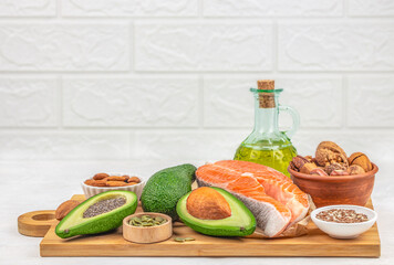 balanced diet, cooking, culinary and food concept, fresh raw salmon fillet, avocado, nuts, Omega 3...