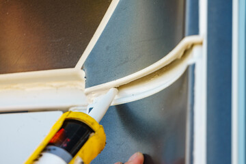 Applying silicon on caravan body