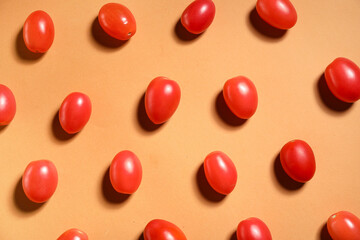 Fresh cherry tomatoes on orange background