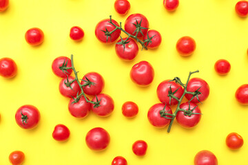 Fresh cherry tomatoes on yellow background