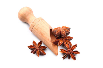 Wooden scoop with star anise on white background