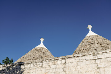 Typical cone roof in the Trulli houses in South Italy, Puglia Alberobello on a blue sunny day