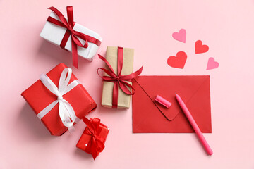 Envelope with paper hearts and gift boxes on pink background. Valentine's day celebration