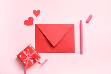 Envelope with paper hearts and gift box on pink background. Valentine's day celebration