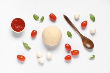 Raw dough, wooden spoon and ingredients for preparing pizza with mozzarella on white background