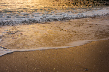 The wave breaks on the shore. White sea foam silhouette