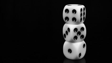 Three white 6-sided dice stacked on top of each other on a black background
