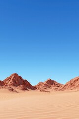 Naklejka premium A vast desert landscape featuring striking red mountains against a clear blue sky.
