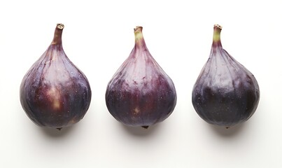 Three ripe dark purple figs arranged in a row