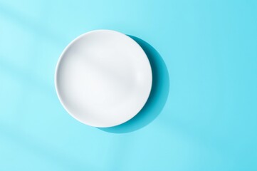 Minimalist White Plate on a Bright Blue Surface with Soft Shadows