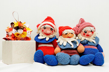 Three small crocheted gnomes and paper flower ball 