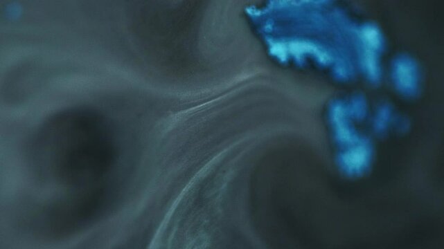 Ink glitter. Smoke cloud. Mystical paint art. Dark gray mixed white shiny particles texture liquid flow acrylic dark hypnotical waves.