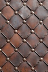 Fototapeta premium Close-up of intricately woven dark brown leather with decorative metal studs, adding a vintage touch.