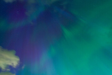 Stunning Aurora borealis display, green and purple lights paint the night sky.