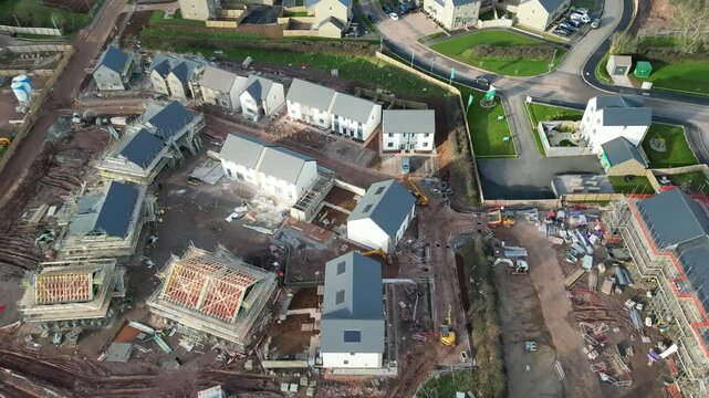 Paignton, South Devon, England: DRONE VIEWS: A new build house development under construction on green belt land at White Rock. Paignton is a popular UK holiday resort (Clip 2).