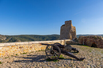 Two historical cannon on old stone floor and stone walls in old historical castle