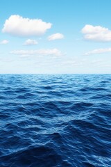 Obraz premium A serene view of a vast ocean under a bright blue sky with fluffy clouds, capturing the essence of tranquility.