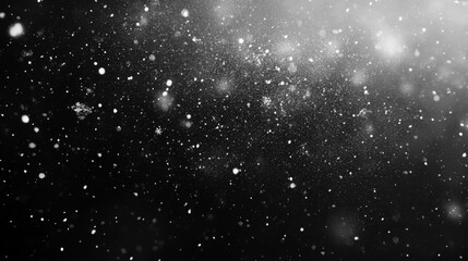 Fototapeta premium Falling snowflakes in a dark black background with scattered light and depth