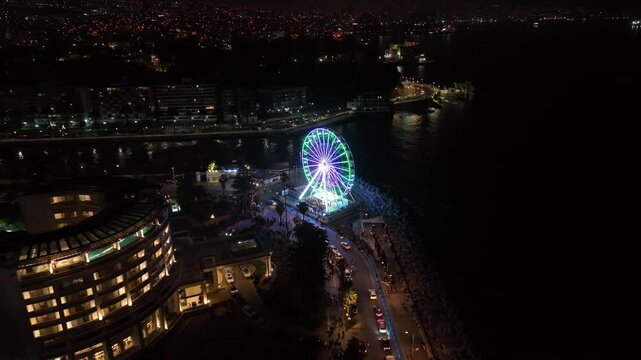Aereal view Illuminated Ferris wheel at night in Vina del Mar Chile