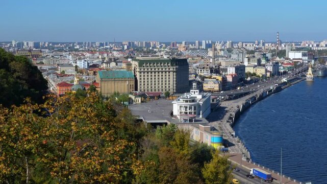 Kyiv, Ukraine - October 9, 2024: Scenic view of Poshtova Square in Kyiv, highlighting the lush greenery and the Dnipro River alongside urban architecture.
