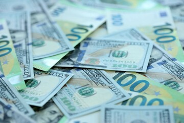 Big pile of Euro and USD banknotes. Many european and united states dollars