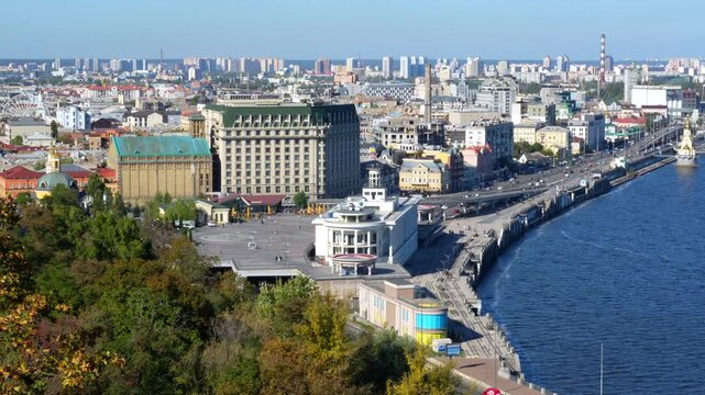 Kyiv, Ukraine - October 9, 2024: Overview of Poshtova Square in Kyiv, showcasing the Dnipro River and vibrant city architecture surrounded by greenery.