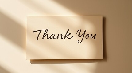 Thank you note in elegant script on beige card