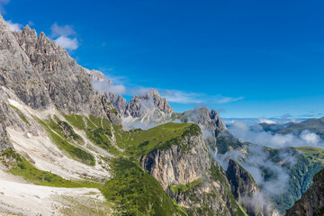 Dolomites sunny weather in summer mountains. Green valley and beautiful mountain rocky peaks in the Alps. Alpine scenic landscape in South Tyrol region in Italy