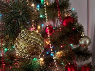 Close up of balls on christmas tree. New Year concept. Red white and gold coloured fake tree