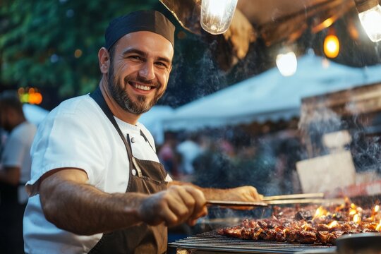 BBQ chef. Man grilling meat at barbecue at outdoor event. Man looking successful, positive and proud. Arabian male happy cook in white hat preparing food meat, making grill at culinary celebration