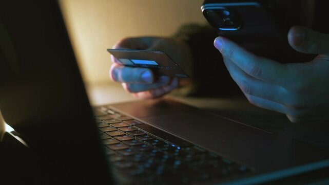 The bank card is in the hands of a man. A person pays for services with a card. Online payment for services. Businessman with a bank card in his hands. Banking operations. Online shopping. Payment