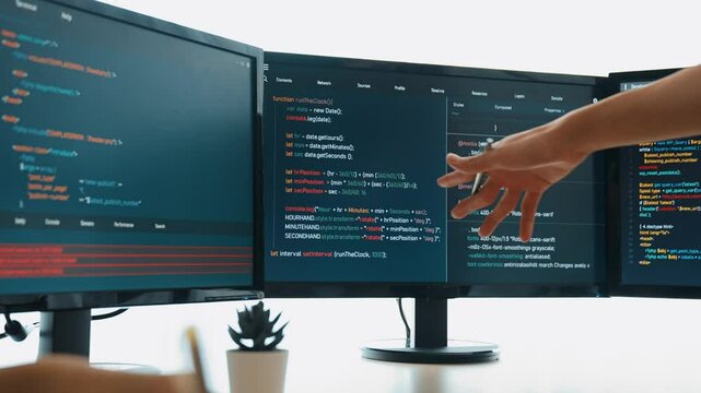 Slow motion back end software developer engineer for computer programming working together on debugging writing computing code, solving complex algorithms display on monitor in office. Burgeoning