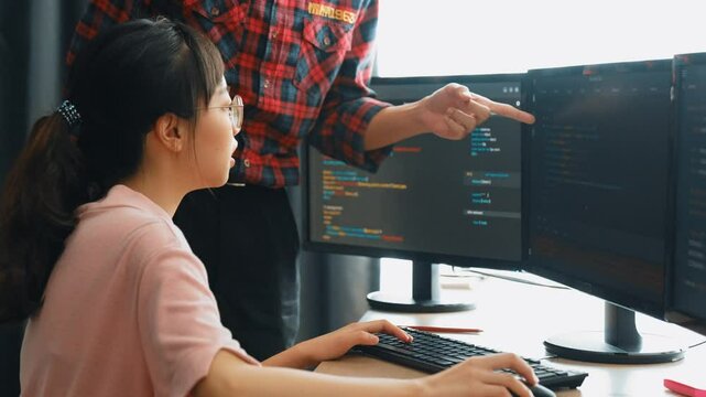 Slow motion back end or software developer manager supervising his team on new application program development on debugging and solving complex code algorithms on monitor. Burgeoning