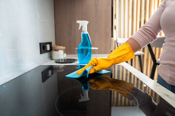 Housekeeper cleaning the kitchen, gas stove, cleanliness concept