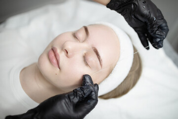 Ladies indulge in a pampering session, receiving permanent makeup procedures in a serene salon...