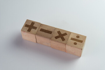 Mathematical Symbols Including Minus, Plus, Multiply, and Divide Icon on wooden cubes concept for Learning, Education,Calculation,Mathematics.