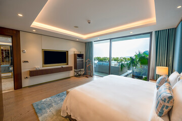 Modern hotel room with a bright and airy feel, a luxury hotel room. Example of a hotel room, modern furnishings and architecture.
