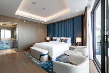 Modern hotel room with a bright and airy feel, a luxury hotel room. Example of a hotel room, modern furnishings and architecture.